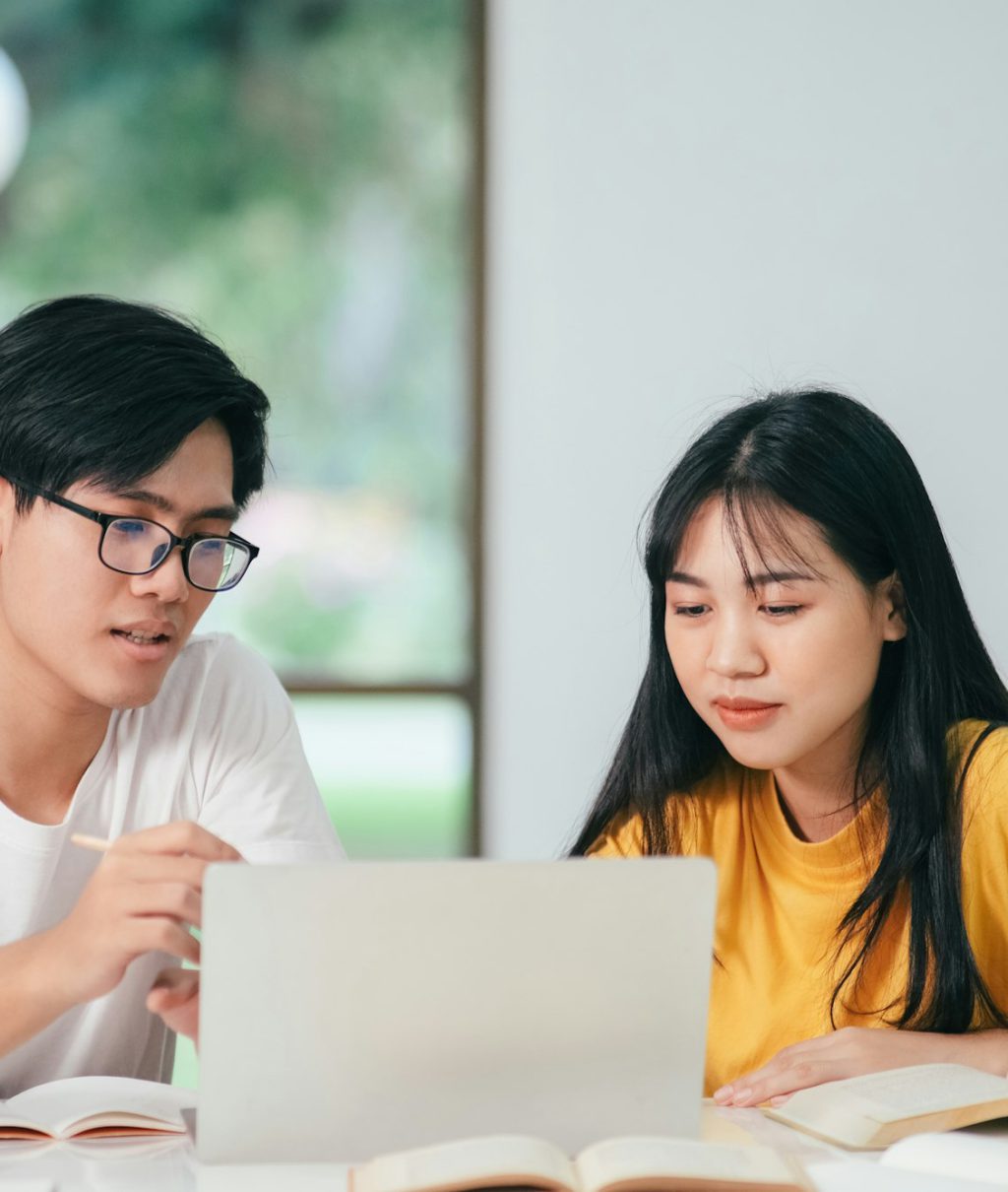 Young asian students campus helps friend catching up and learning.